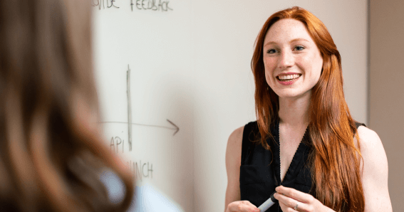 image of teacher in classroom talking to a student