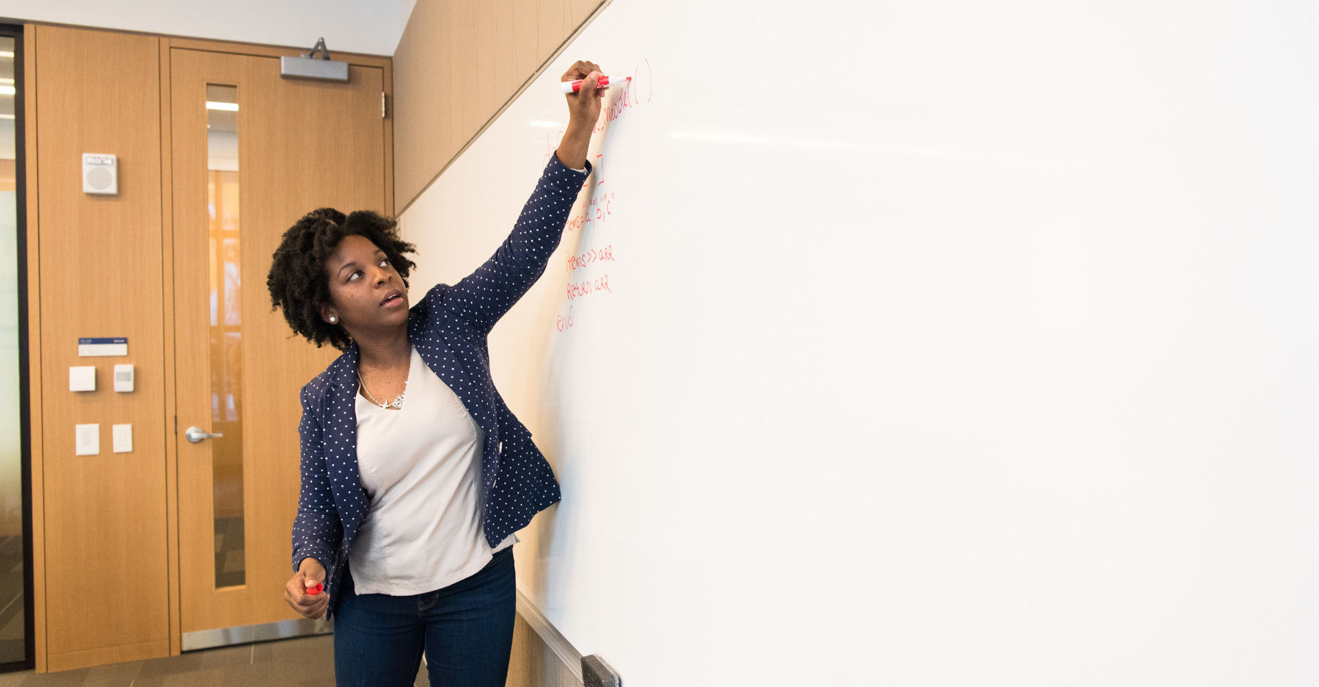 teacher writing on the whiteboard