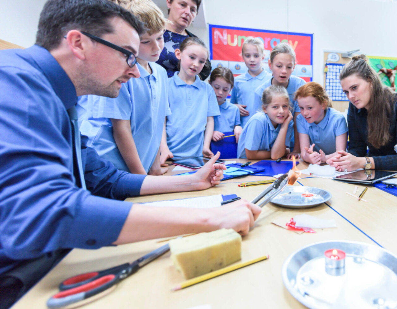 teacher showing children a science experiment