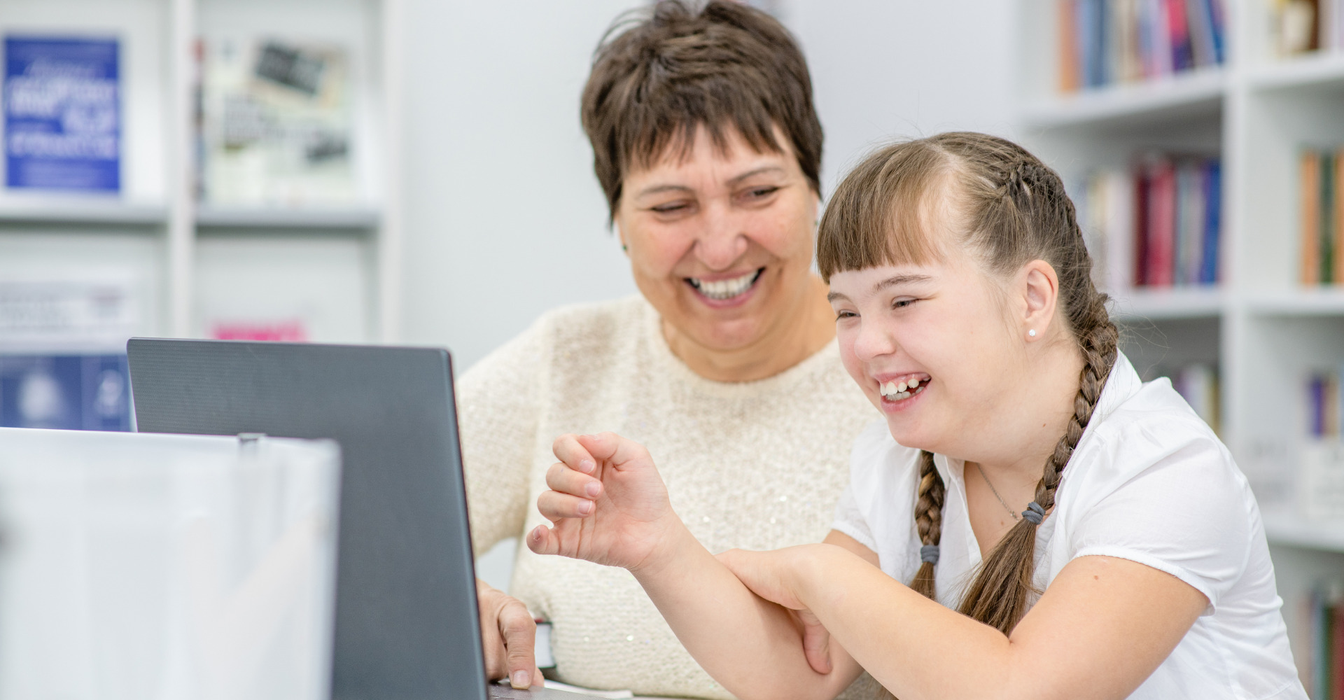 teacher helping a sen student on the computer