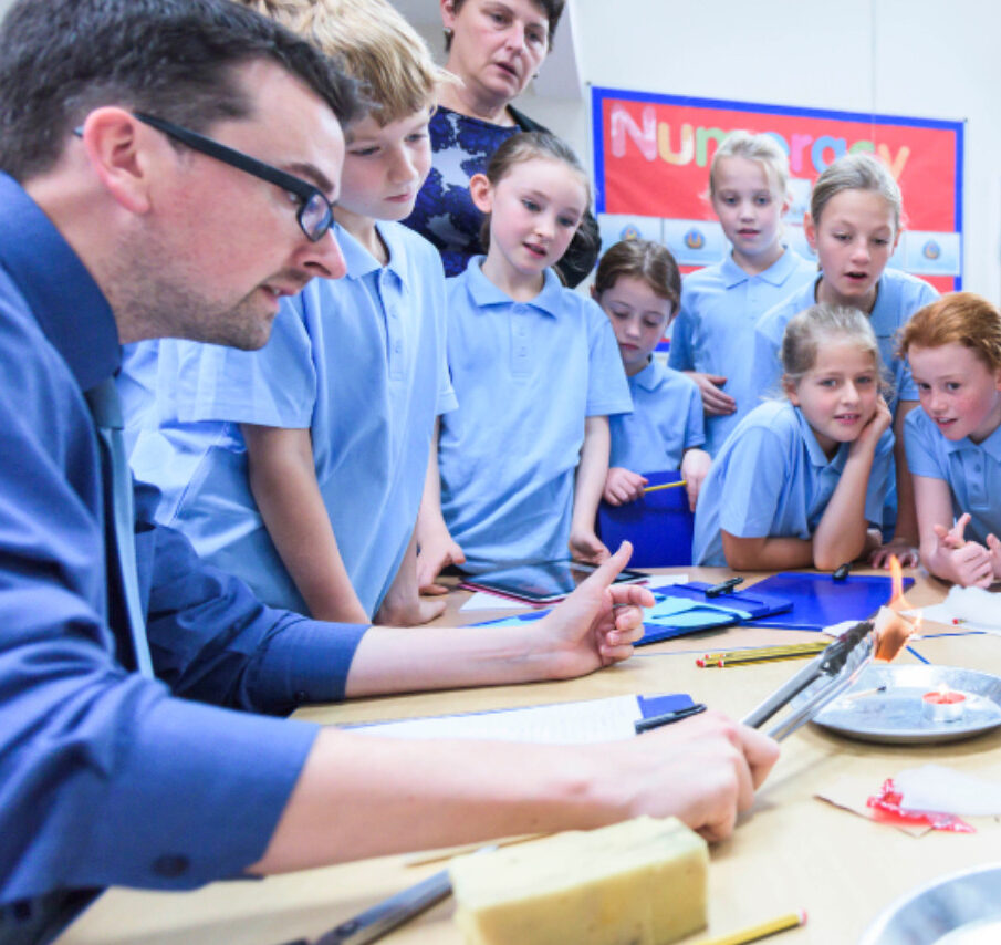 teacher showing children science experiment