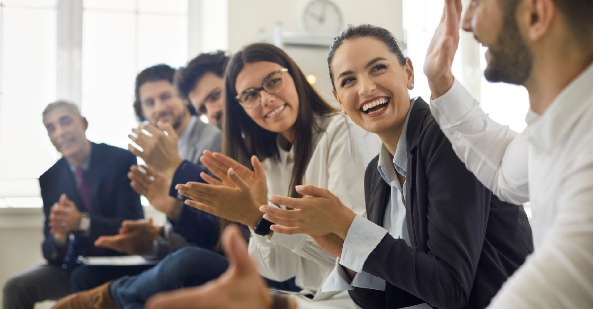 image of team clapping and smiling