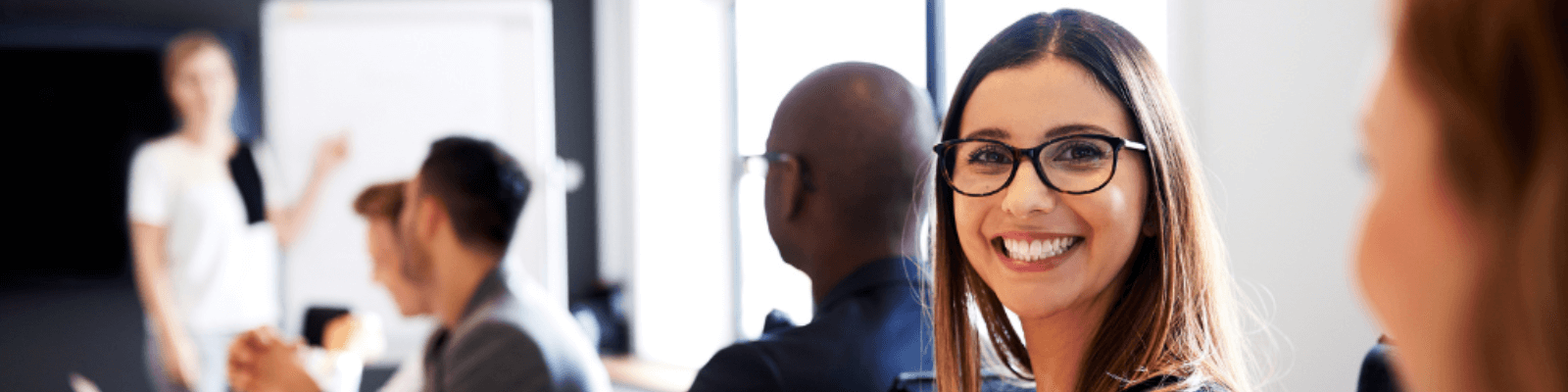 woman smiling in a meet wearing glasses